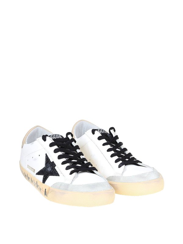 GOLDEN GOOSE: trainers online - Superstar sneakers in black and white leather