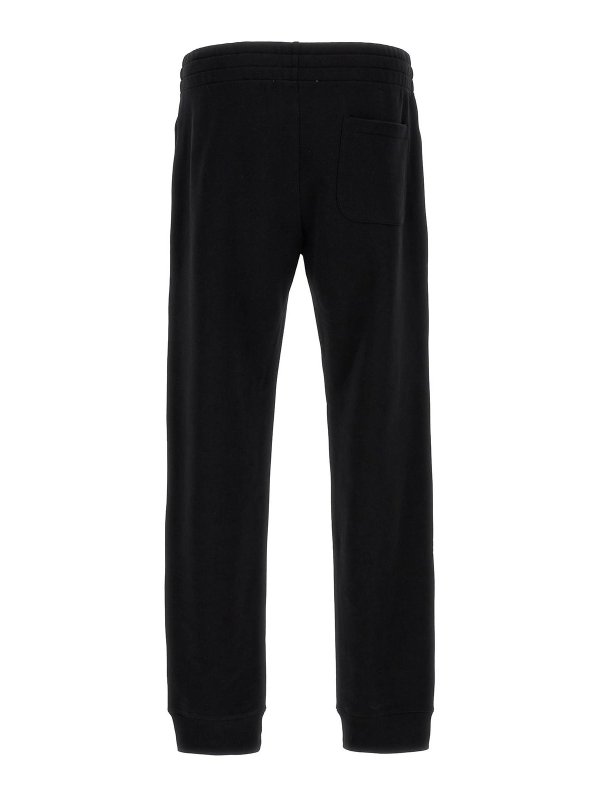 MOSCHINO: スウェットパンツ online - トラックスーツ ボトムス - 黒