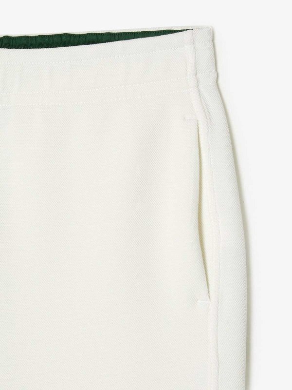LACOSTE: スウェットパンツ online - トラックスーツ ボトムス - クリーム
