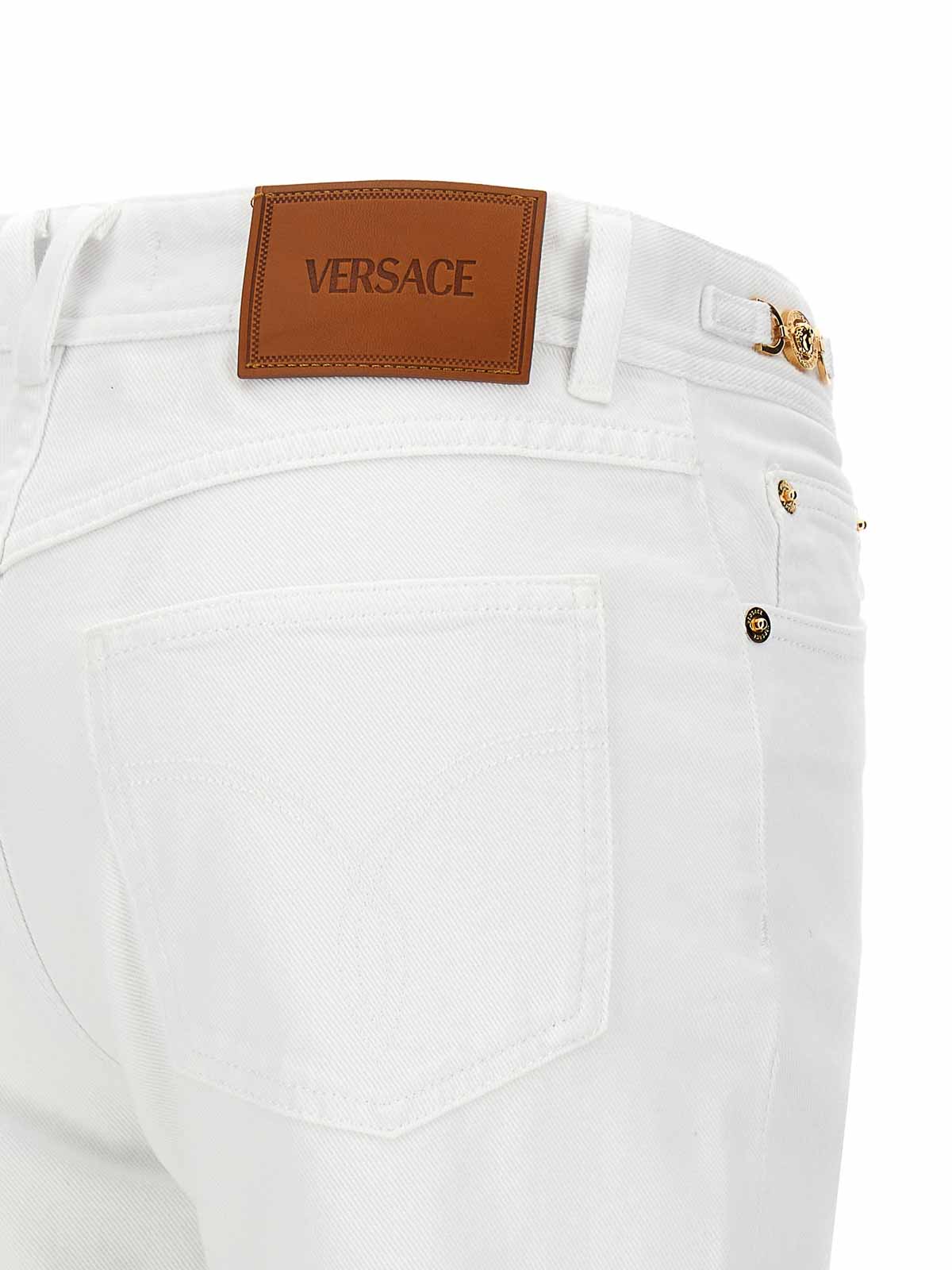 Shop Versace Flared Jeans In White