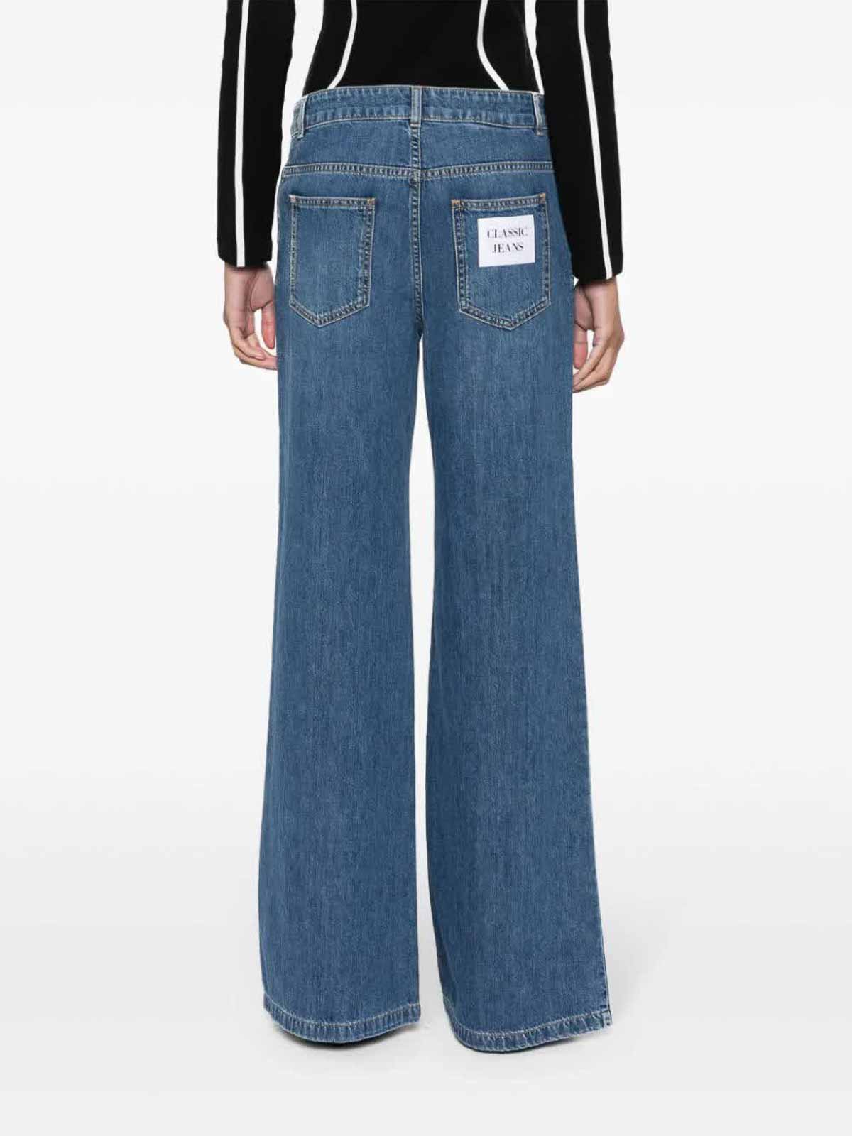 Shop Moschino Straight Leg Jeans In Blue