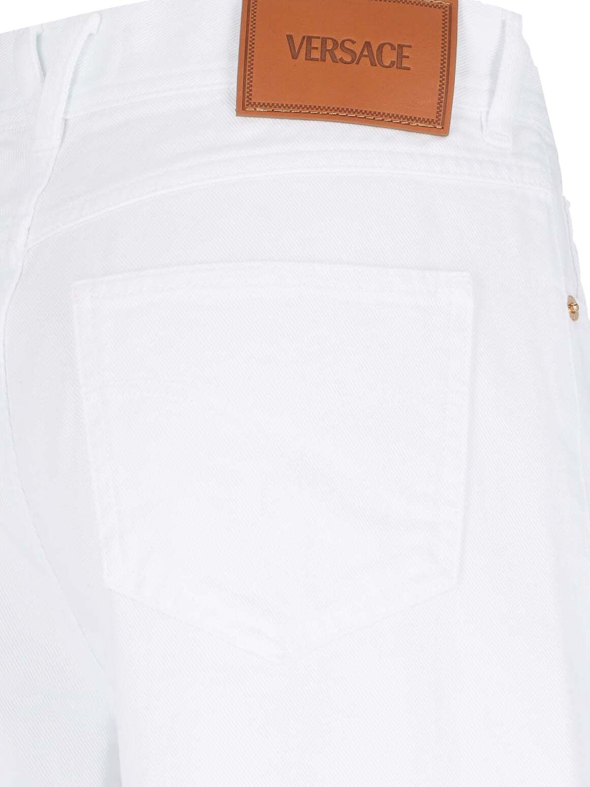 Shop Versace Palazzo Logo Jeans In White